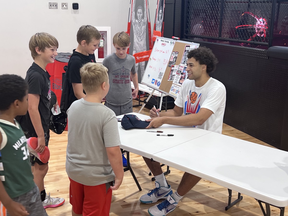 On the last day of camp, Anton Watson spent time taking pictures with his campers and signing autographs.